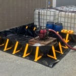 Chatoyer black XR-5 collapsible bund storing a pump, IBCs and other containers of liquids