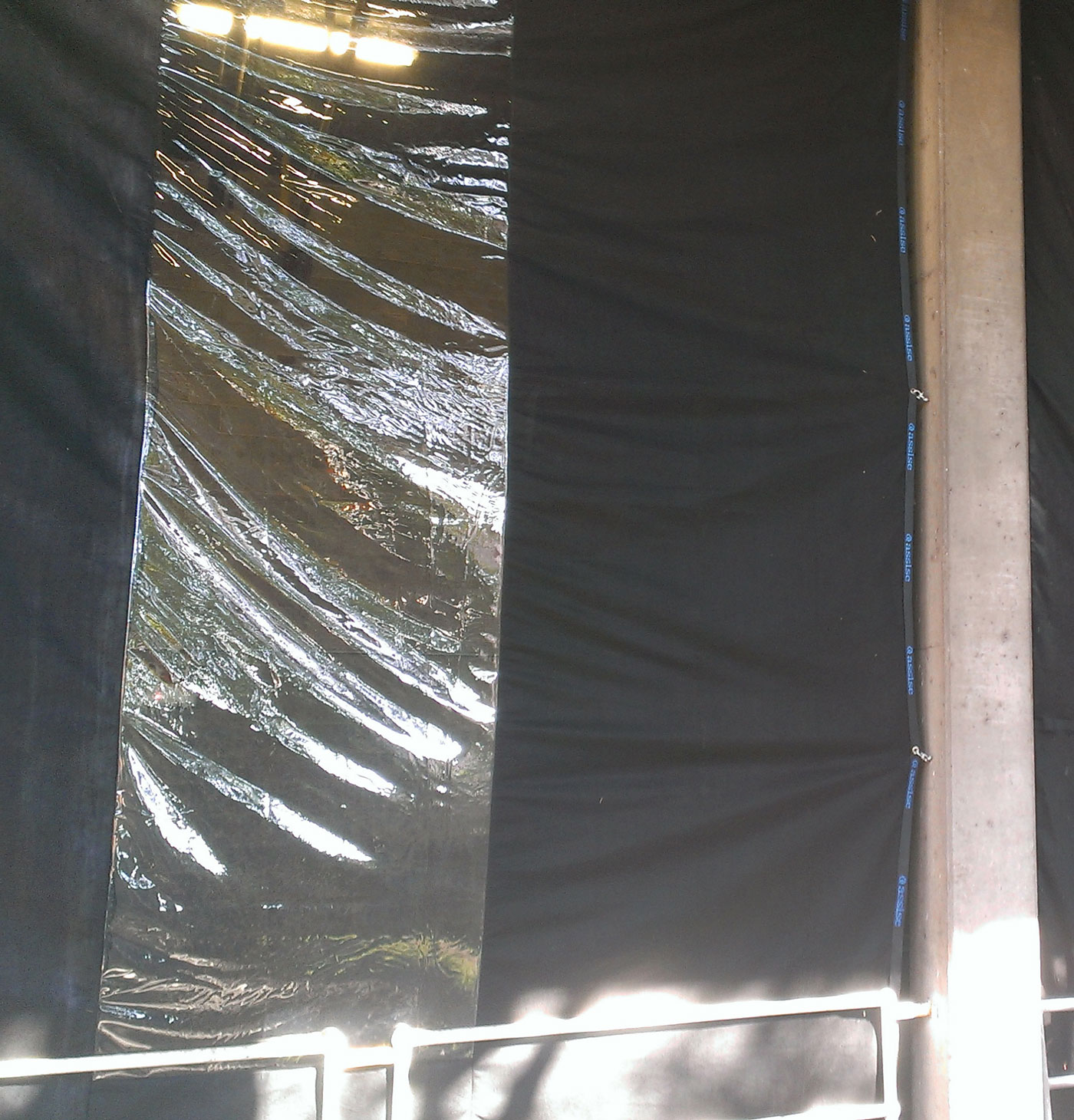 odour control hanging curtain attached to concrete wall